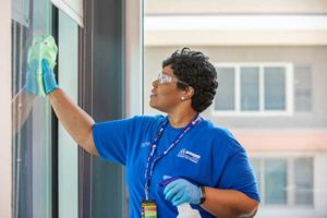 A Janitorial team member cleans a workplace in coordination with a plan that provides the right staff, materials, equipment, and a custom service schedule for best value and satisfaction