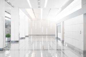 A clean commercial facility with sparkling white floor, walls, and ceiling, well-lit by clean lighting