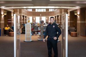 Uniformed security guard at the secure entrance of a commercial facility