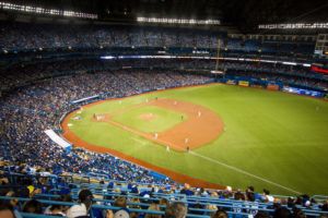 A baseball stadium during a game illustrating the importance of a clean, healthy, and safe stadium for the happy experience of visitors